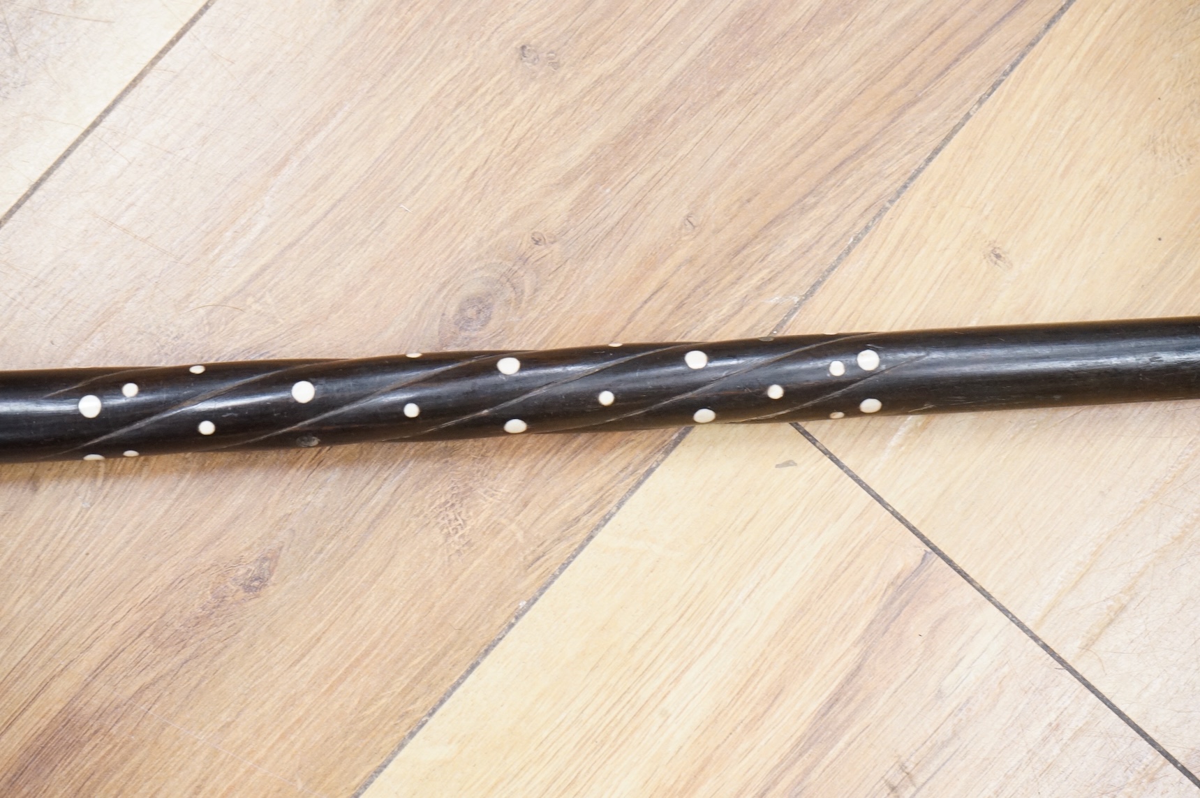 An ebony walking stick with bone inlay, the handle in the form of a dog's head, 88cm in length